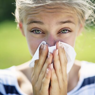 2022 Allergy Season - Young woman blowing her nose
